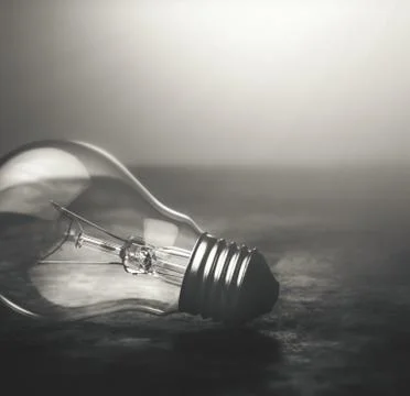 Dark tone lightbulb lamp on the floor dramatic background concept. Stock Photos