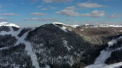 Dark trees and white mountains in winter in Kolashin, Montenegro Stock Footage 152342186