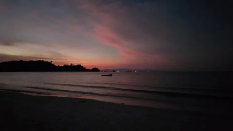 Dark Tropical Shoreline During Dramatic Evening Sunset Stock Footage 338333027