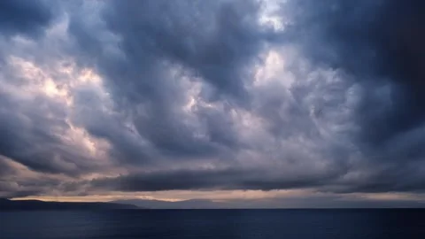 Dark tropical storm clouds with colourful lights moving against the sky Stock Footage 258170391