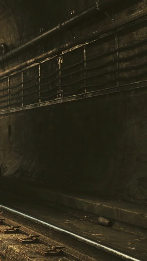 Dark tunnel with train tracks and metal bars in abandoned location 스톡 동영상 334196214