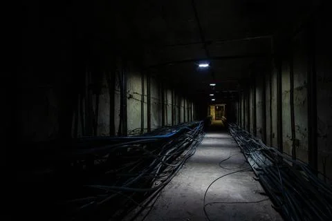 Dark underground cable tunnel with a cable coupling in the foreground. Unde.. Stock Photos