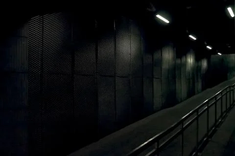 Dark underground corridor with metal railing Stock Photos