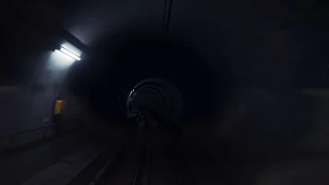 Dark underground subway tunnel with lanterns on the walls. Stock Footage 129600850