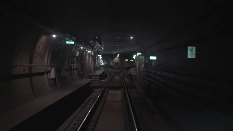 Dark underground train tunnel, deep down, subway car rides on rails in the Stock Footage 134384299