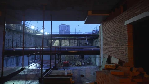 Dark unfinished corridor opens slowly to construction gap Stock Footage 316098396