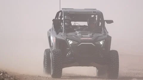 Dark UTV Side by Side Vehicle Approaching Through Heavy Desert Dust Cloud Stock Footage 332963003