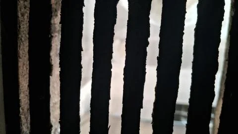 Dark vertical metal bars creating a sharp abstract geometric pattern Stock Photos