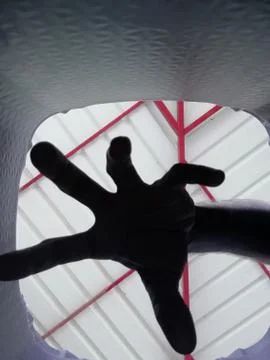 The dark view of the fingers put inside a hole Stock Photos