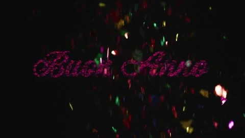 Dark void starting with red particles forming cursive Buon Anno while confetti Stock Footage 319342717
