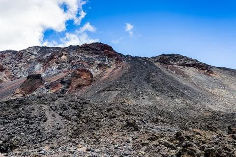 Dark volcanic slopes under blue sky in La Palma Stock Photos