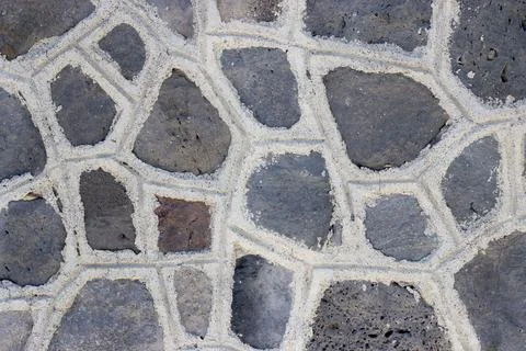 A dark wall made of angular stones Foto stock