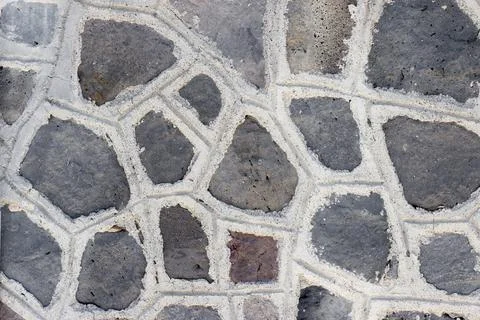 A dark wall made of angular stones Stock Photos