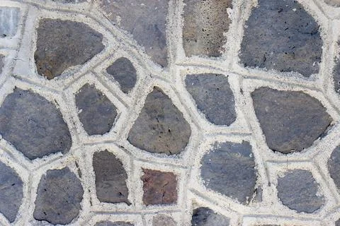 A dark wall made of angular stones Stock Photos