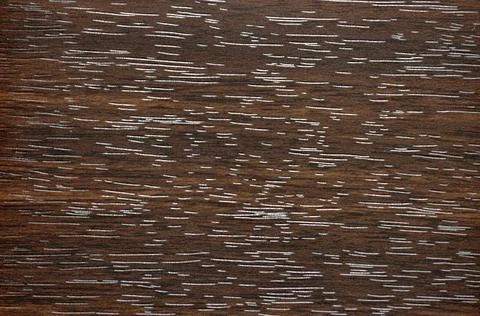 Dark walnut, flat polished surface of natural wood with a heightened pattern. Stock Photos