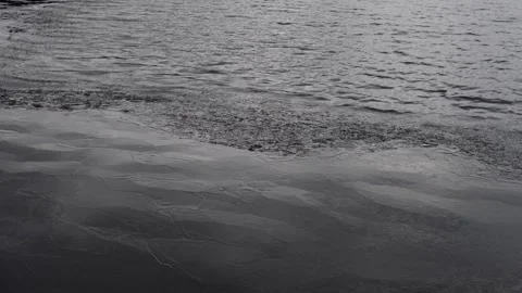 Dark Water surface with melted ice in wind with reflections. Climate change. Stock Footage 169441581