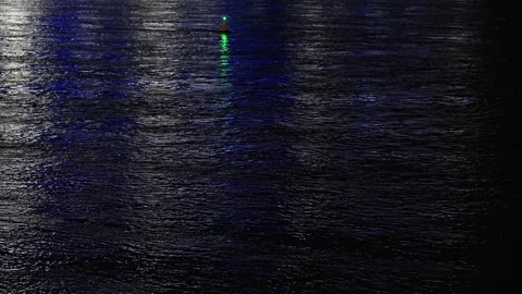 Dark water surface at night reflecting city and buoy lights. Stock Footage 342371948