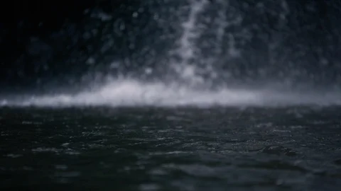 Dark water surface with waterfall in background in super slow motion Stock Footage 90363693