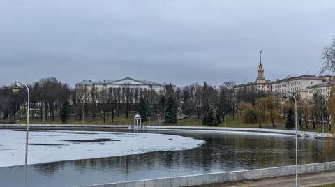 Dark waters of the river with thin plates of ice. The first ice on the river  Stock Photos