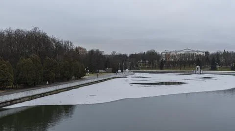 Dark waters of the river with thin plates of ice. The first ice on the river  Stock Photos