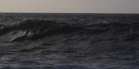 A dark wave rolling to explode on a rocky reef Stock Footage 59525253