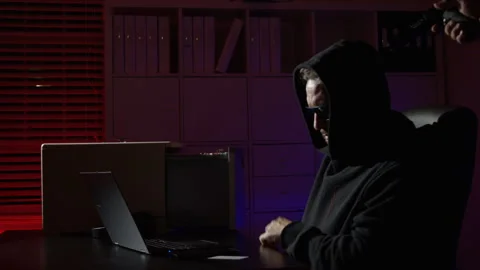 Dark Web and Cyber Security. Hacker typing code in laptop at night office Stock Footage 346684715