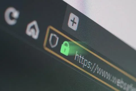 Dark web browser close-up on LCD screen with shallow focus on https padlock Stock Photos