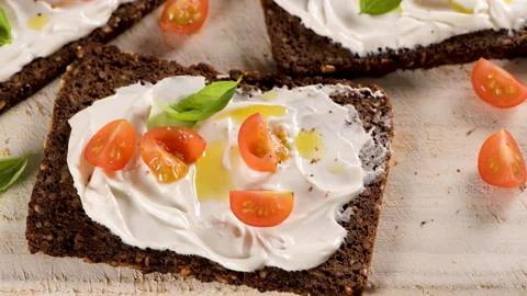 Dark Whole Grain Rye Bread Slices Spread with Cream Cheese and Cherry Tomatoe Stock Photos