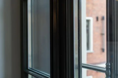 Dark window frame with glass inside a residential building. Vintage interior Stock Photos