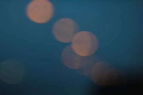 Dark window rain mood at dawn, bokeh lights Stock Photos