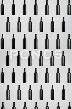 Dark wine bottles. Creative dark and textured abstract background. Stock Photos