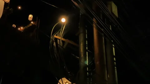 Dark wire cable on a street pole 4k handheld footage Stock Footage 284361748