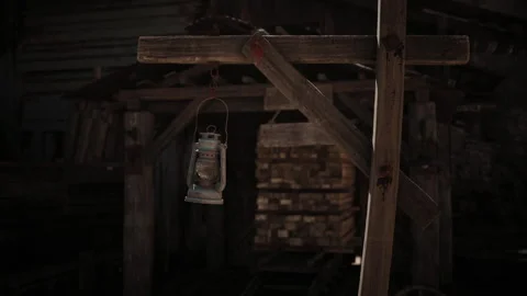 Dark wooden structure with an old lantern hanging, set in a rustic location Stock Footage 331400064