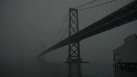Darkness Falls over Bay Bridge Covered in Smoke Stock Footage 139656296