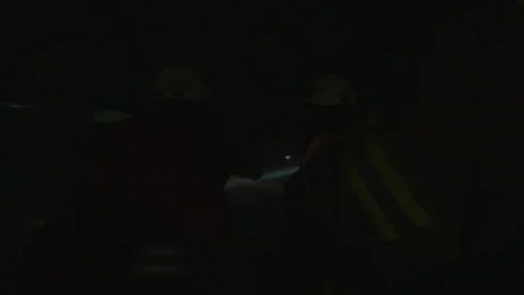 Darkness As A Flashlight Beam From Firefighters Sweeps Around The Room With Stock Footage 266407944