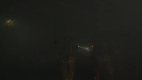Darkness As A Flashlight Beam From Firefighters Sweeps Around The Room With Stock Footage 266408777