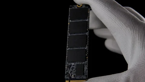 In the Darkness: Hand Securely Grasping High-Speed M.2 SSD for PC Stock Footage 270468965