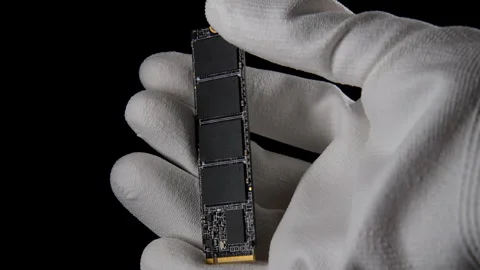 In the Darkness: Hand Securely Grasping High-Speed M.2 SSD for PC Stock Footage 270469451