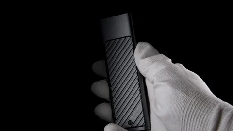 In the Darkness: Hand Securely M.2 SSD Case, External USB Drive Stock Footage 270468937