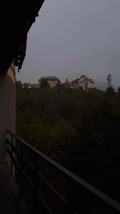 Darkness increasing over remote buildings from balcony Stock Footage 291741687