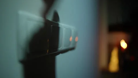 Darkness indoors during blackout with flashlight appearing on wall and female Vídeos de archivo 242705176