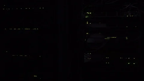 Darkness in the server room. Flashing green server lamp LED. Network ethernet 動画素材 106705936