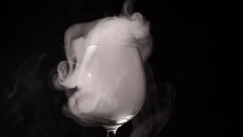 In the darkness the white smoke hovering in an empty clear glass Stock Footage 72094660