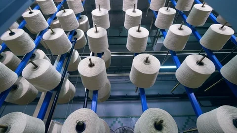 Darning spools with white threads uncoiling from them Stock Footage 107970534