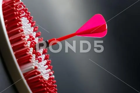 Dartboard with dart arrow hitting the center Stock Photos