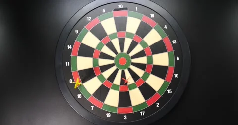 Dartboard isolated on black throwing darts trying to get a bullseye Stock Footage 205429951