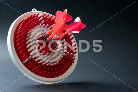 Dartboard with three dart arrows hitting the center Stock Photos