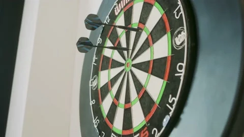 Dartboard while two darts thrown in one dart ist allready on the board Stock Footage 203897476