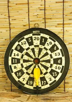 Darts on a bamboo  wall Stock Photos