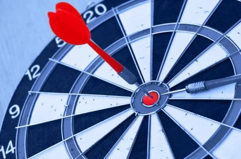 Darts in center of target Stock Photos